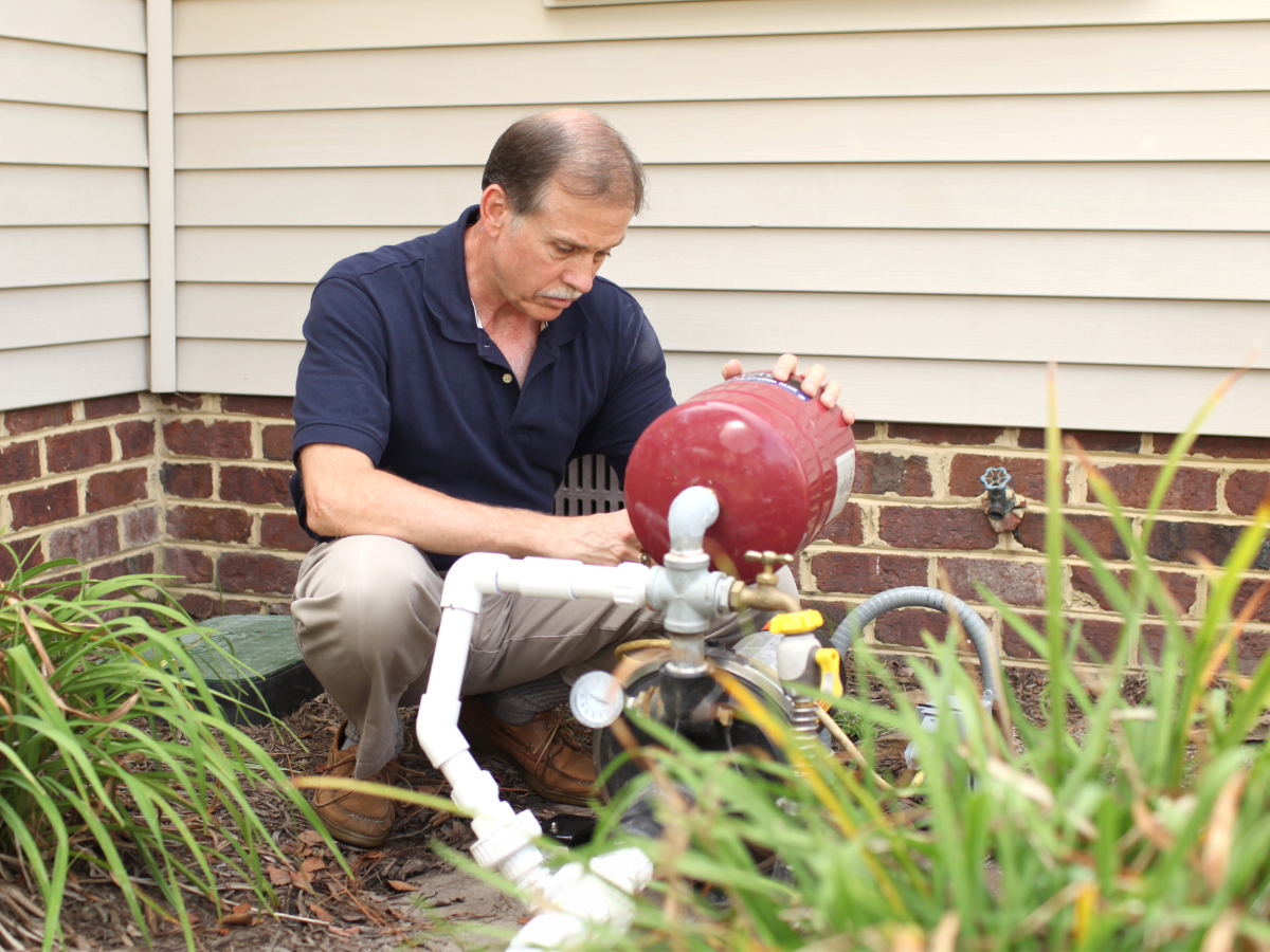Plumber inspecting well pump so it will last many years