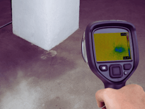 Plumber using thermal imaging to detect slab leak