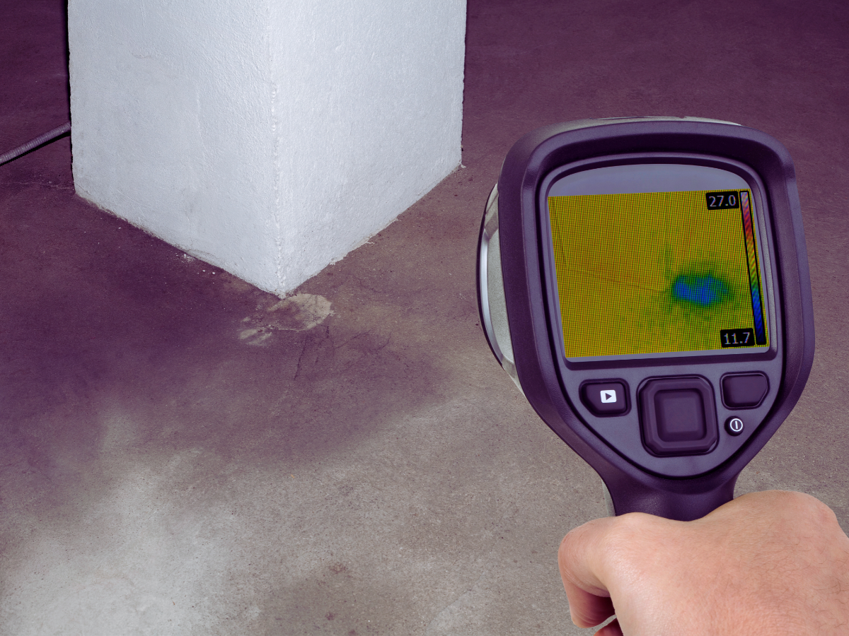 Plumber using thermal imaging to detect slab leak